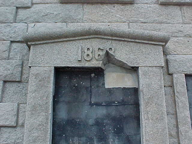 Granite doorway with date above door.